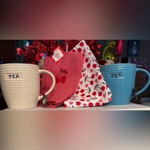 Blue & Cream Tea Mugs along with a set of colorful cherry tea towels.